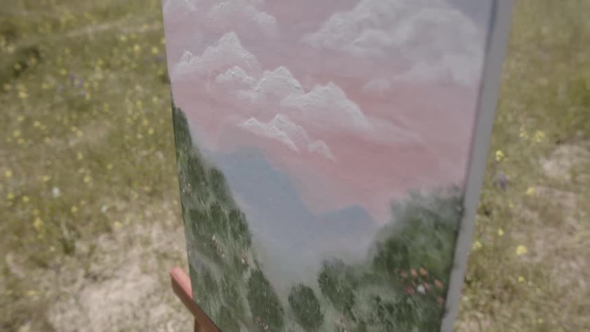 Painting of nature on an easel in the grass