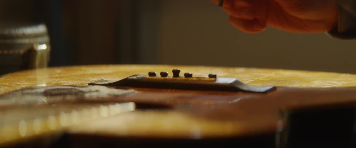 Person removes a string from guitar