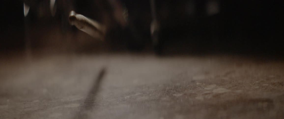 A drumstick falls to the ground