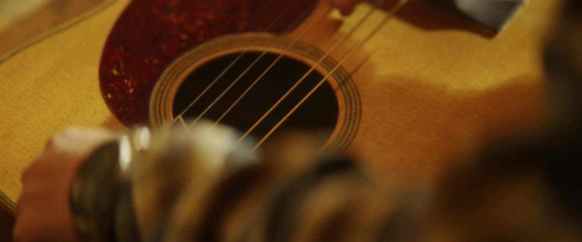 Man tuning a guitar