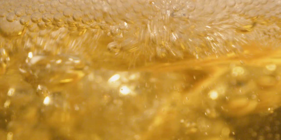 Yellow liquid bubbles as it moves