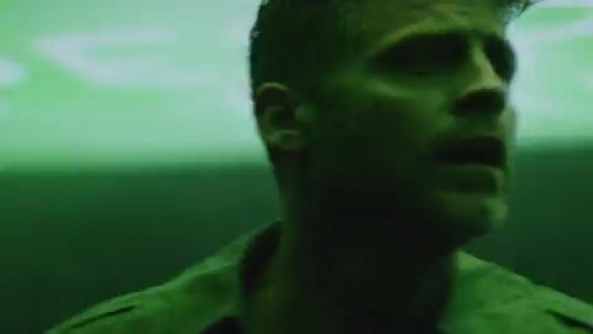 A man stands in a room with flashing lights
