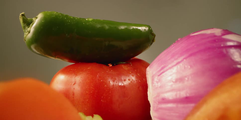 Vegetables are sitting on a cutting board in daylight