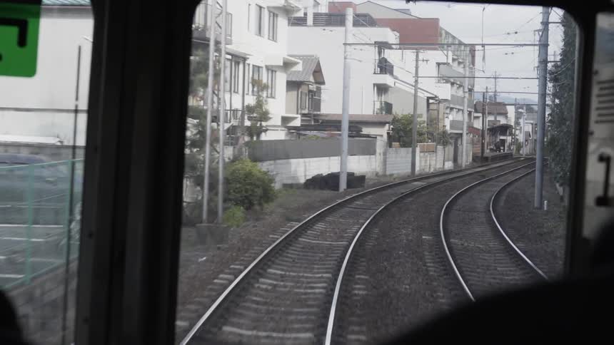 Conductor drives a train down the tracks