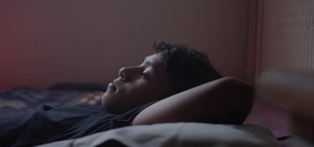 A boy is resting in the bed