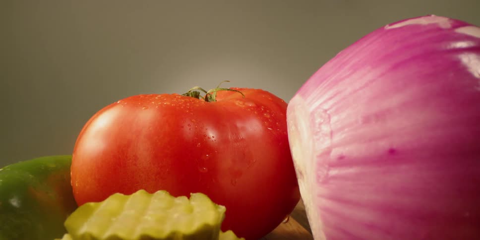 Vegetables are sitting on a cutting board in daylight