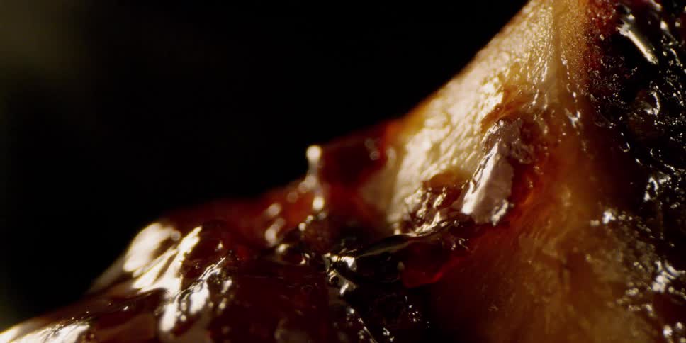 Steam surrounds the glazed meat