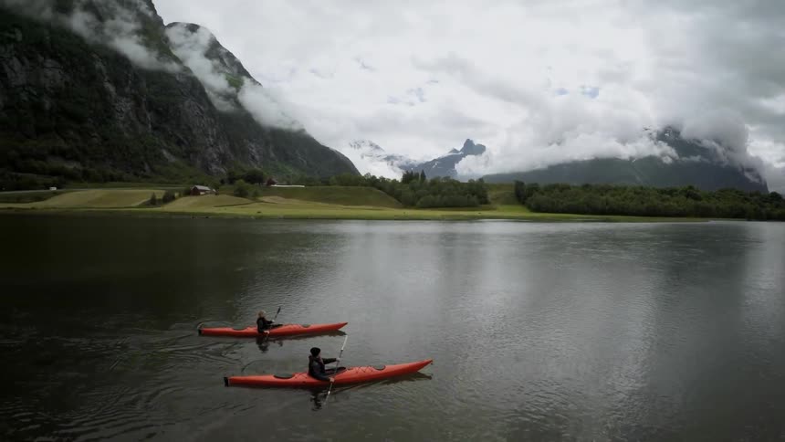 Kayakers paddle on a mountain lake