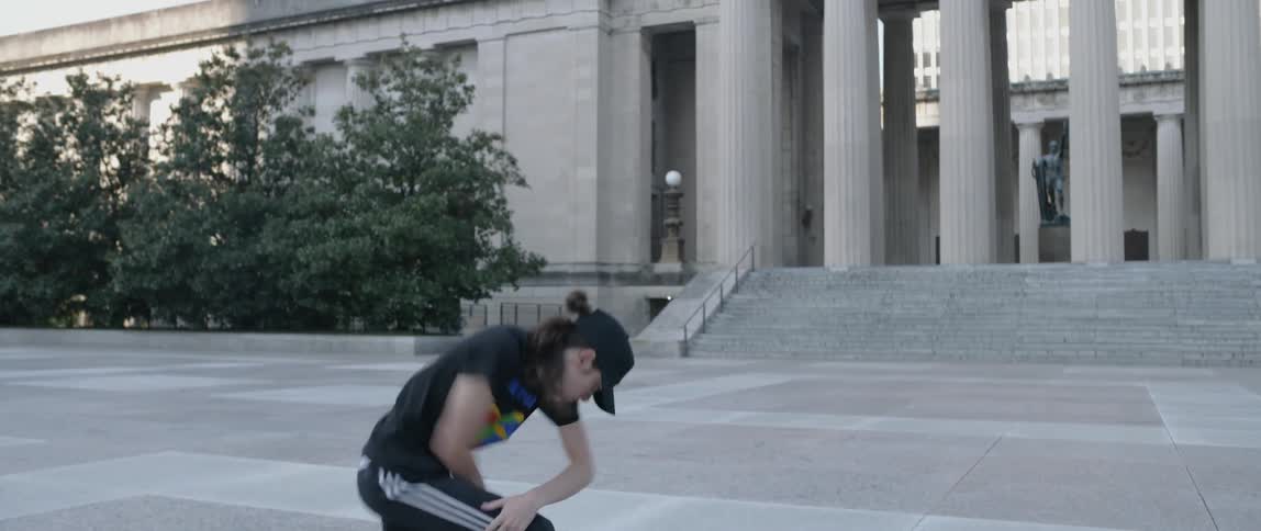 Man dances in an empty city square