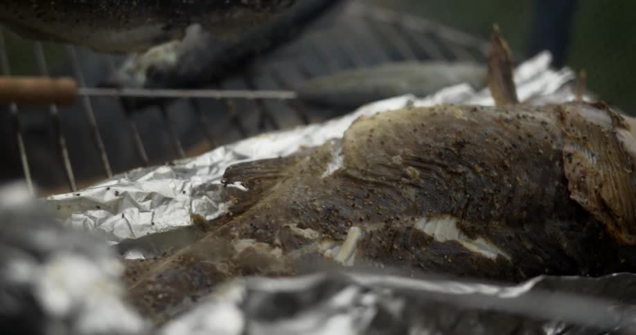 Fish being grilled during the day