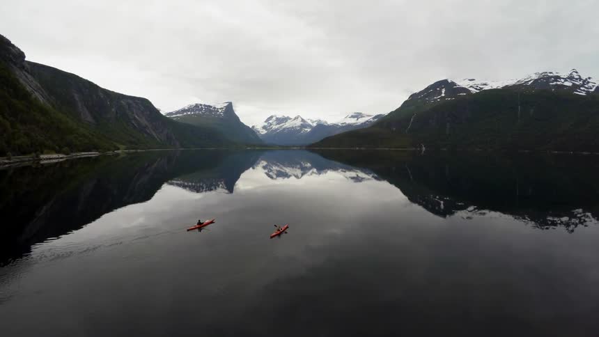 Kayakers float on a mountain lake