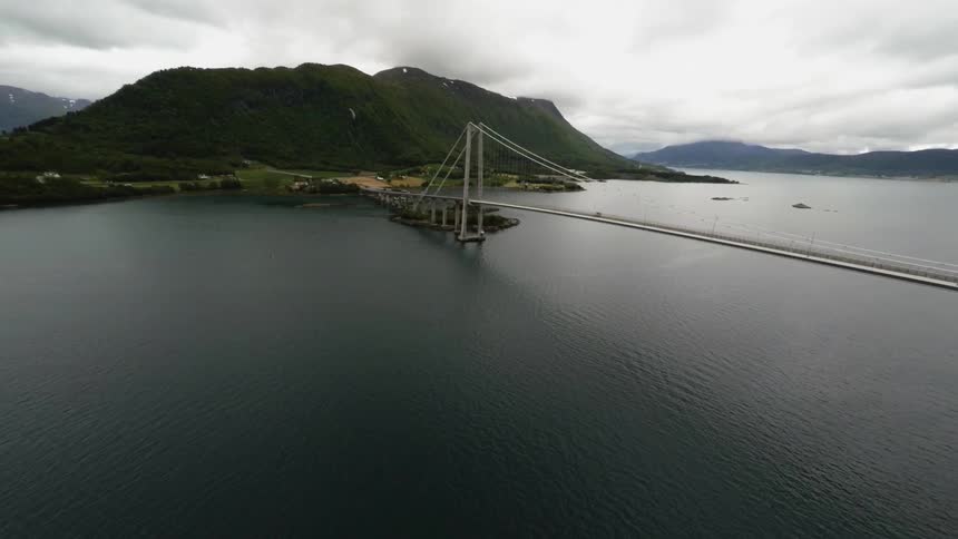 A bridge over calm waters on a cloudy day