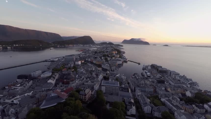 A coastal town is shown from above at dawn