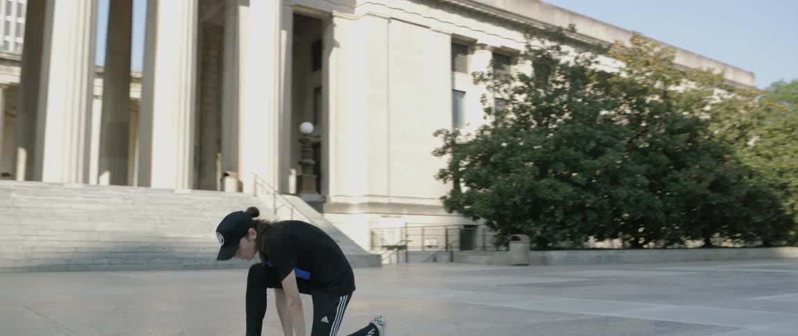 A man dances in an empty city plaza
