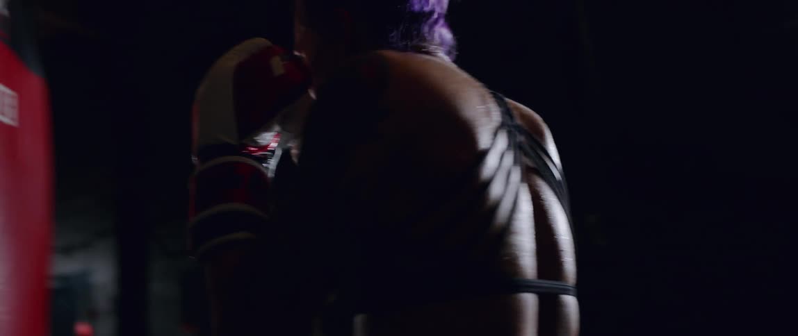A boxer hits a punching bag