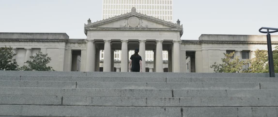 Man waking up stairs in a city during the day