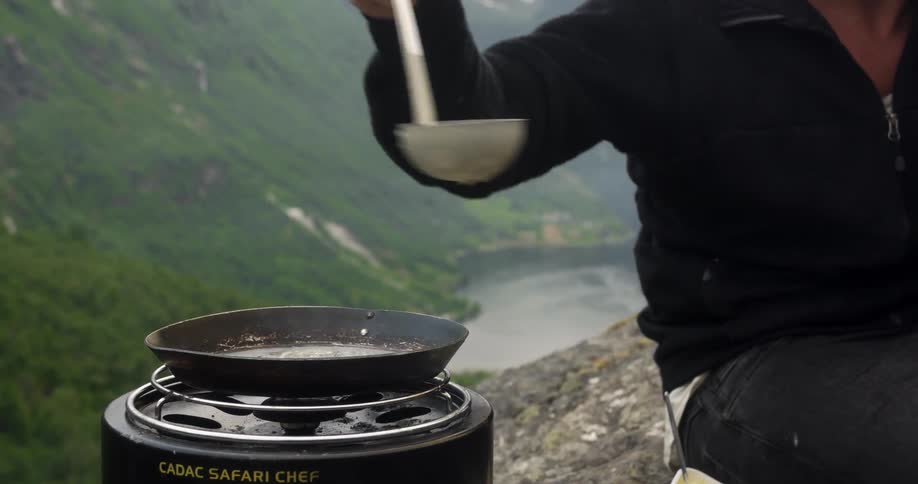 A person cooking outdoors