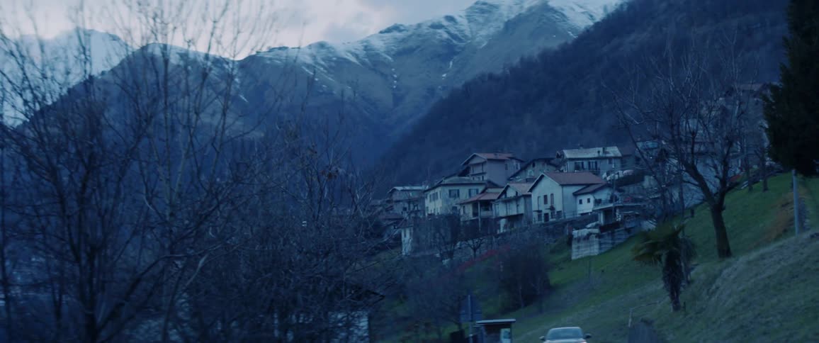 Car dirving up a rural mountain road
