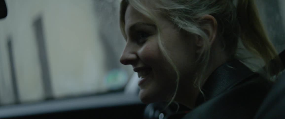 A woman is talking as she rides in a car