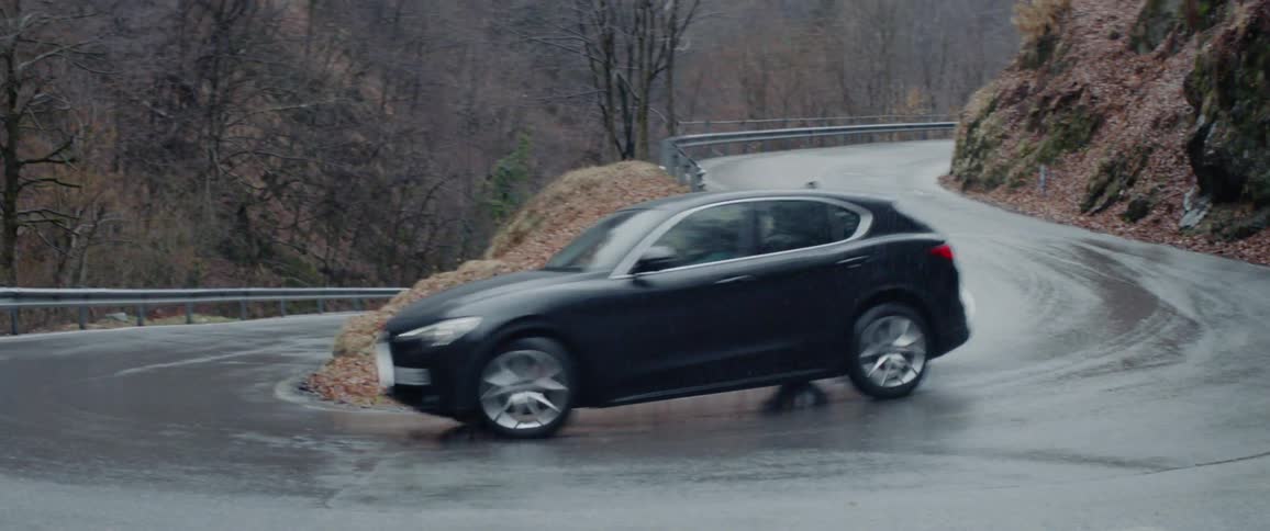 Car driving down a rural mountain road