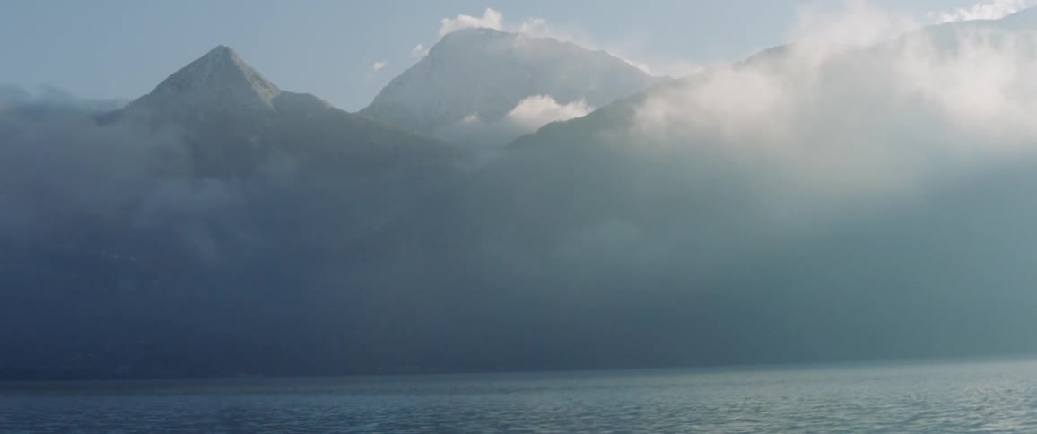 Sun shines over fog and mountains