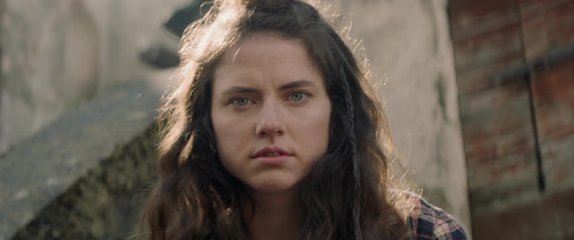 Young woman turns to gaze forward