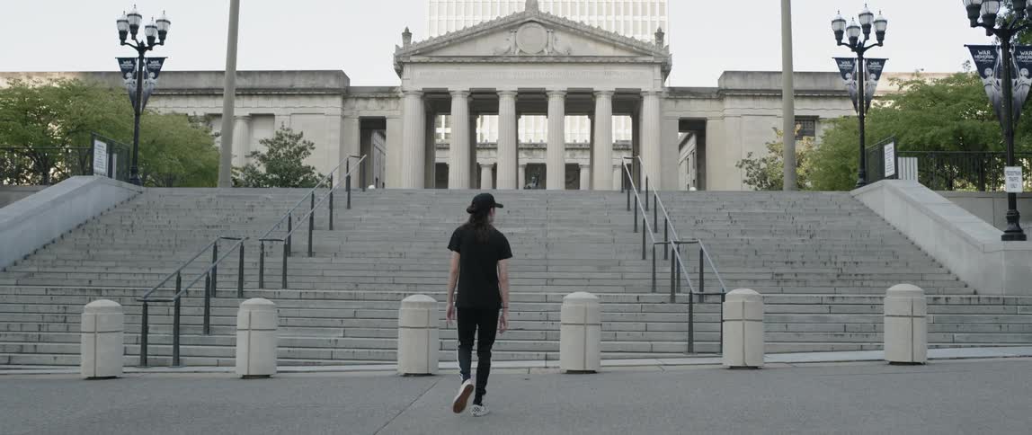 Man walking through a city in the afternoon