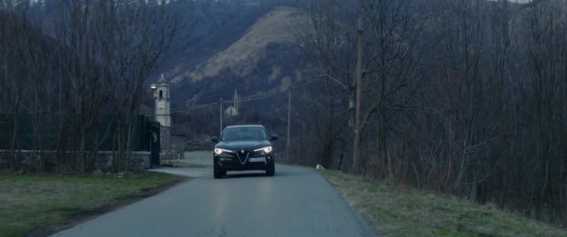 A car drives down the single lane road