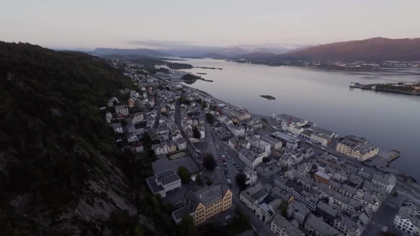 View of a town located on a mountainside next to the water