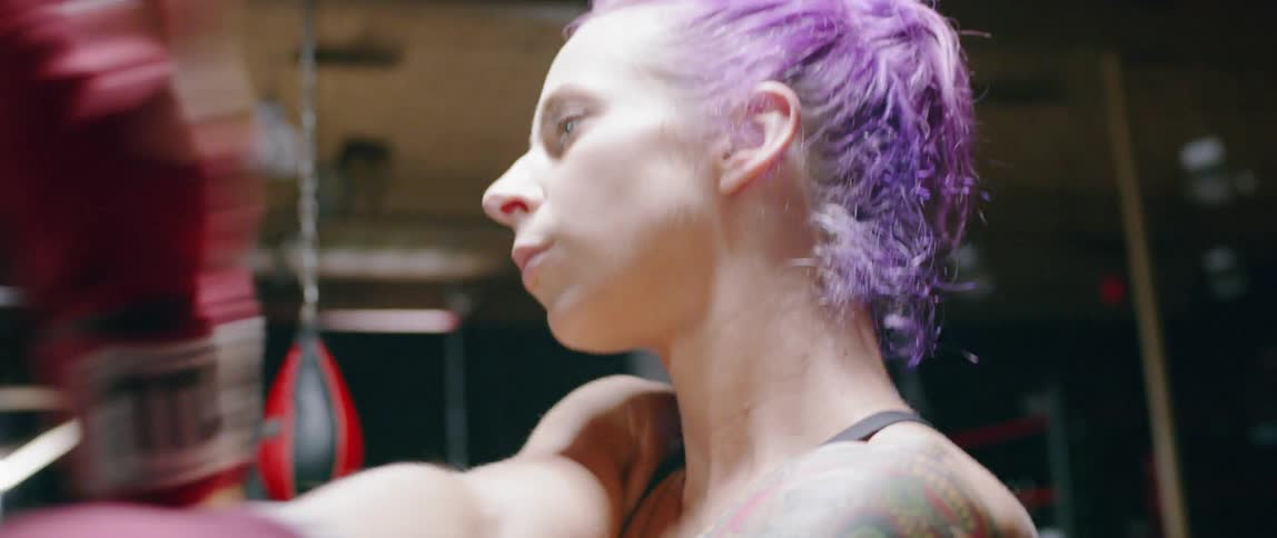 The woman walks in stretching in the gym