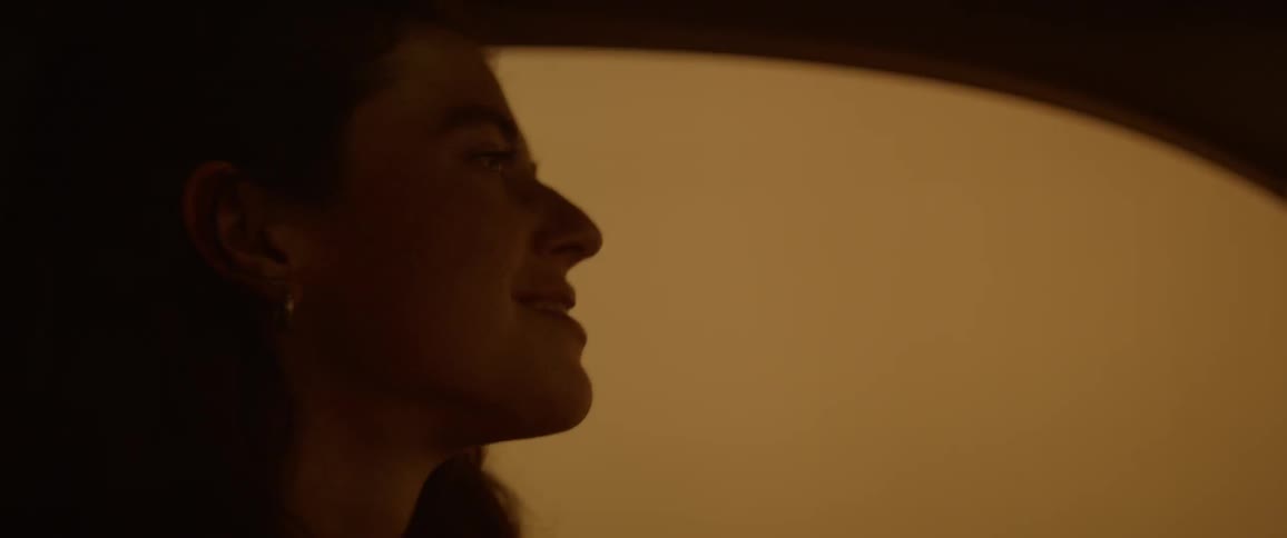 Woman in moving car adjusts hair