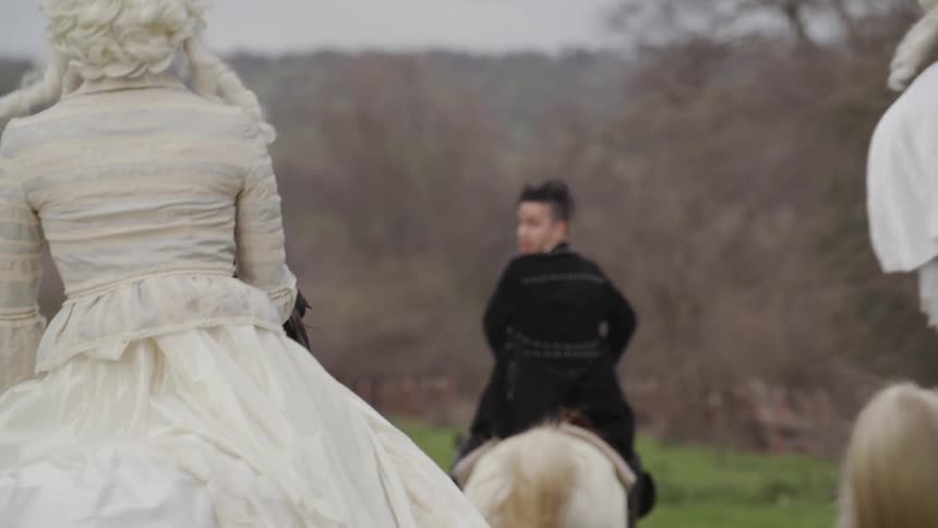 Three people ride on horses