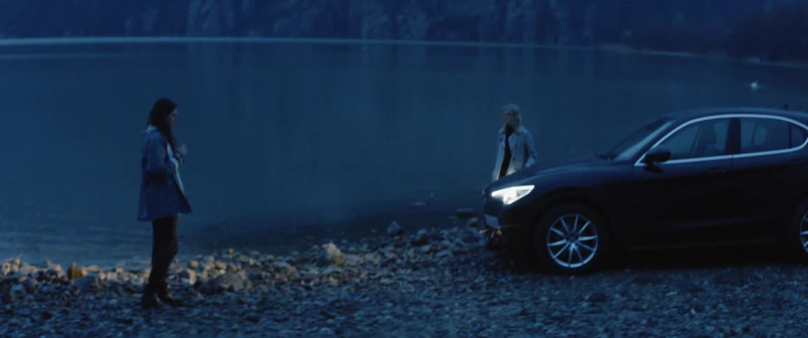 People get out of the car by the lake