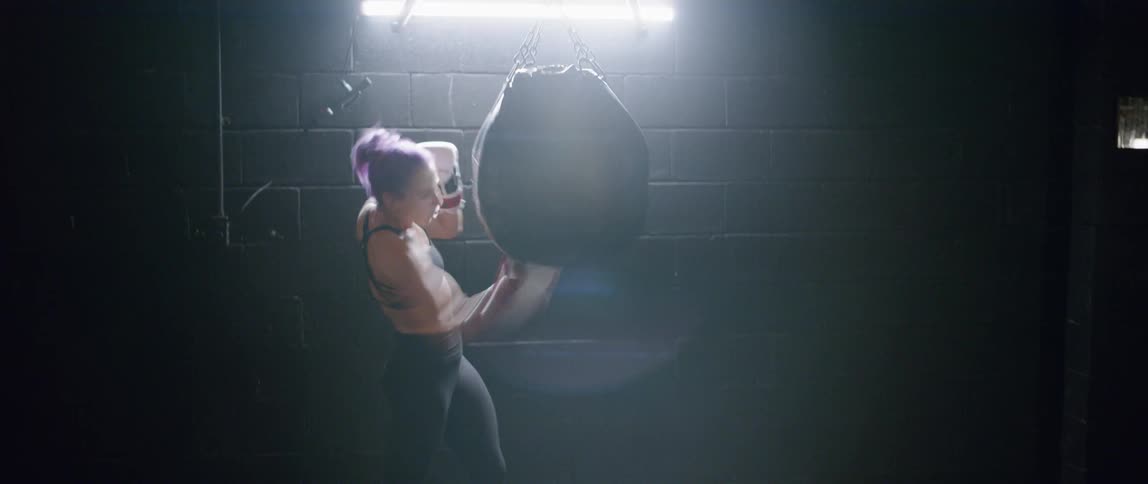 A boxer hits a punching bag