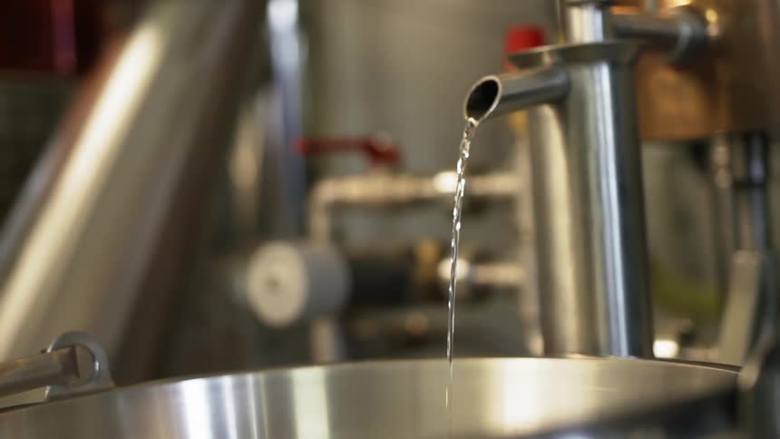 The faucet is pouring into the container