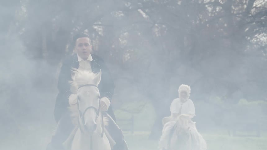 Man riding a horse through the woods