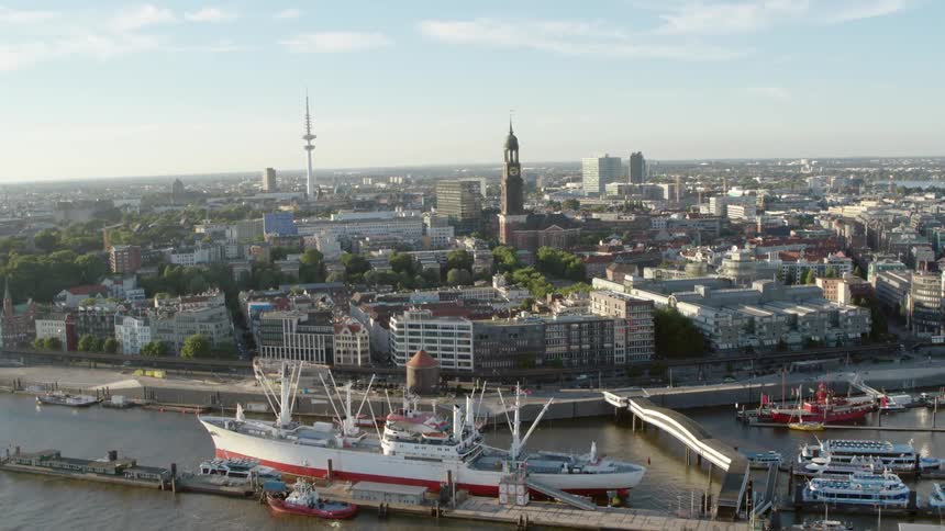 Sun shines over a river and a large city - Hamburg