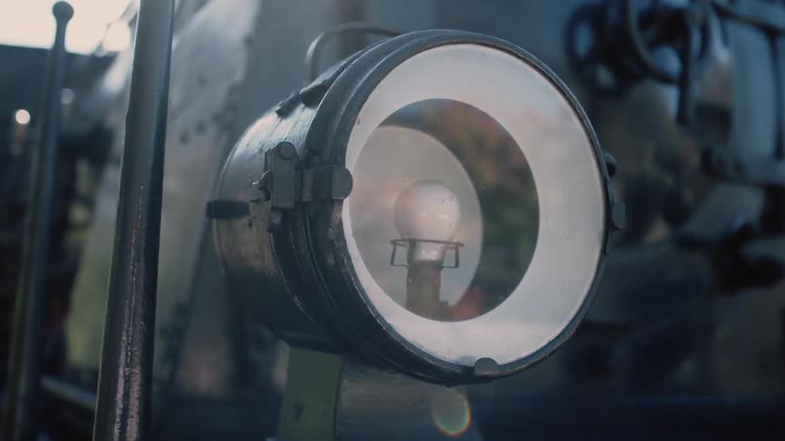 Light bulb in a locomotive with sun shining on it