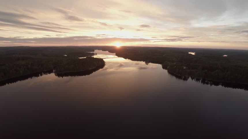 The sun sets over a calm lake