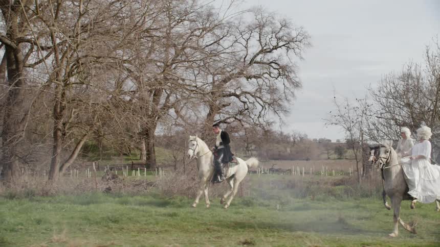 People dressing nice ride horses together