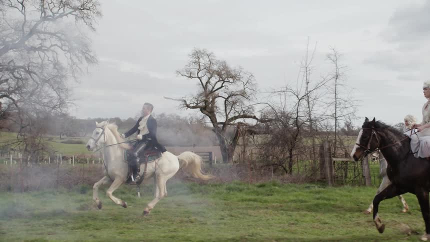 Man in period costume rides horse