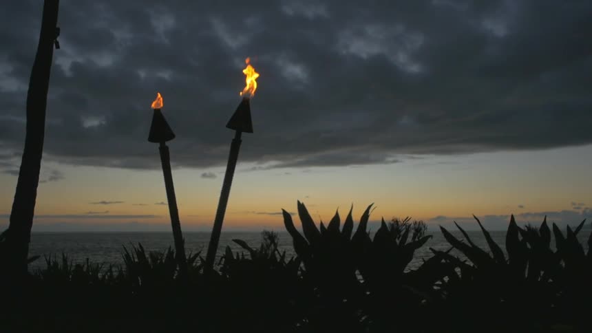 Two torches burn at dusk