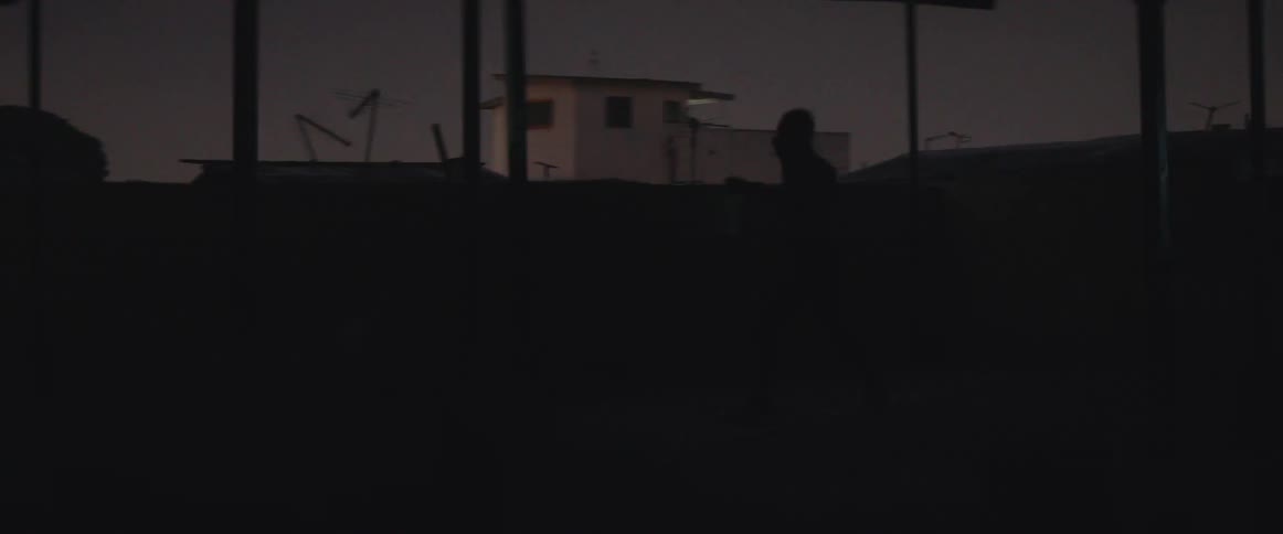 A man is shadowboxing in the dark