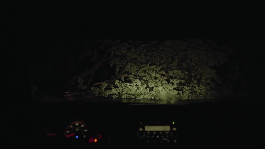 A car drives in the rain at night