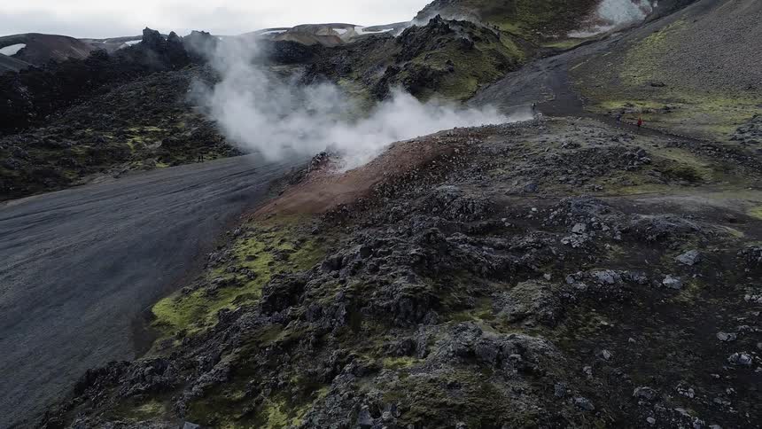 Steam pours from the ground