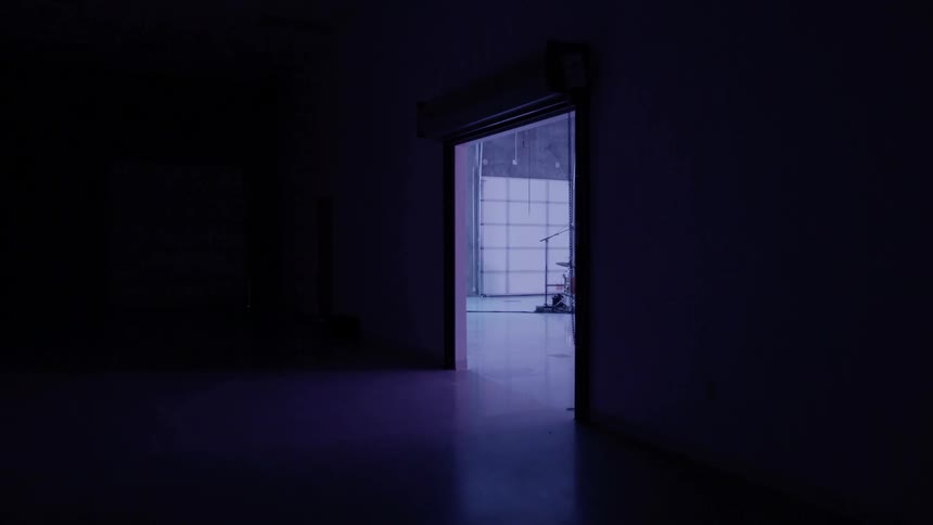A drummer plays in an empty room