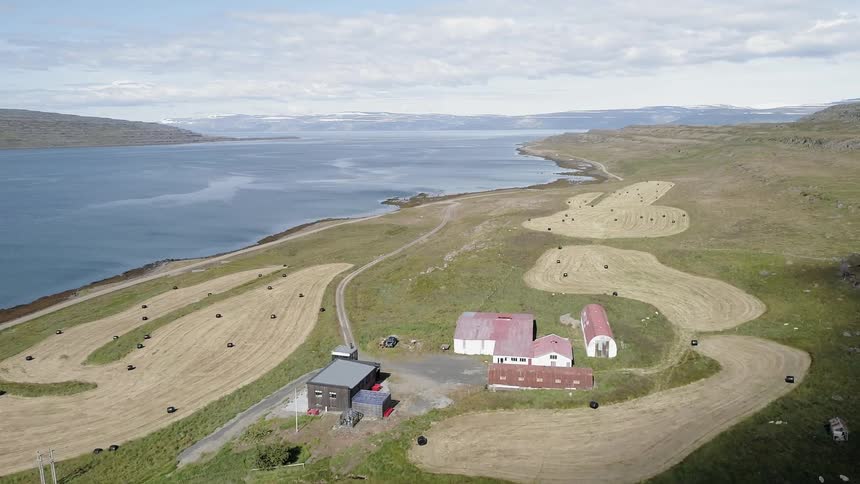A farm sits next to a rural lake