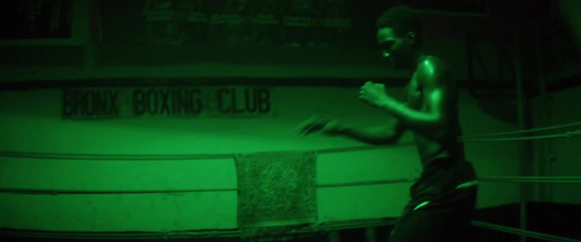 Man shadow boxes in a boxing gym