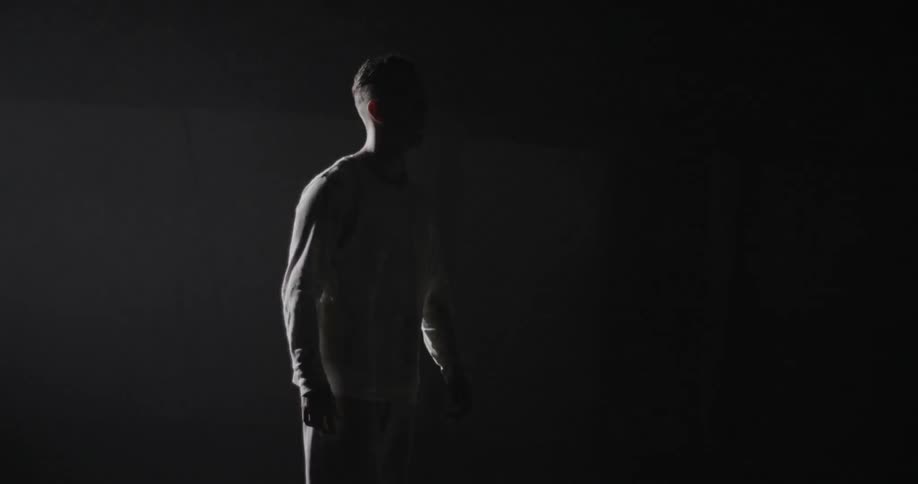 A man is standing in front of fast blinking lights