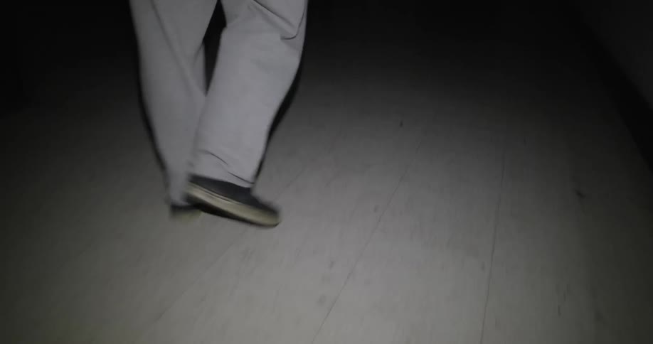 Person walking in the dark in a building